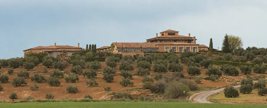 The lodge at El Crespo standing on a hilltop above terraced olive groves