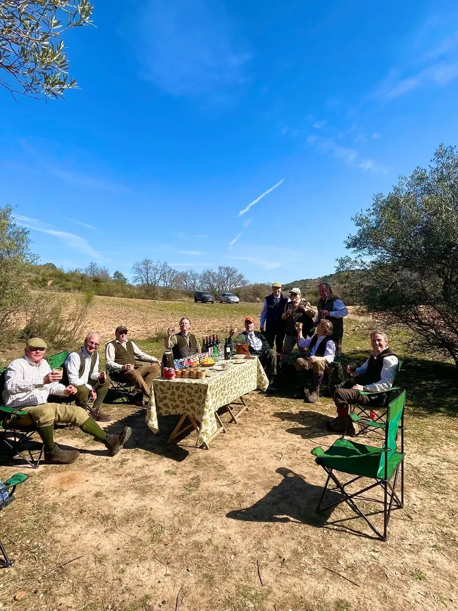 A shooting party at a field lunch at Fuentelfresno, trestle table set out on open ground