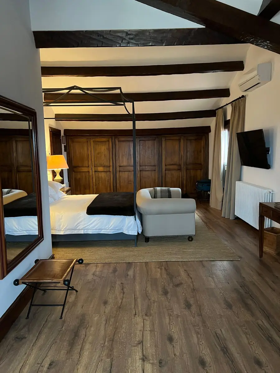 Guest bedroom at La Cuesta with an iron four-poster bed and panelled wardrobes
