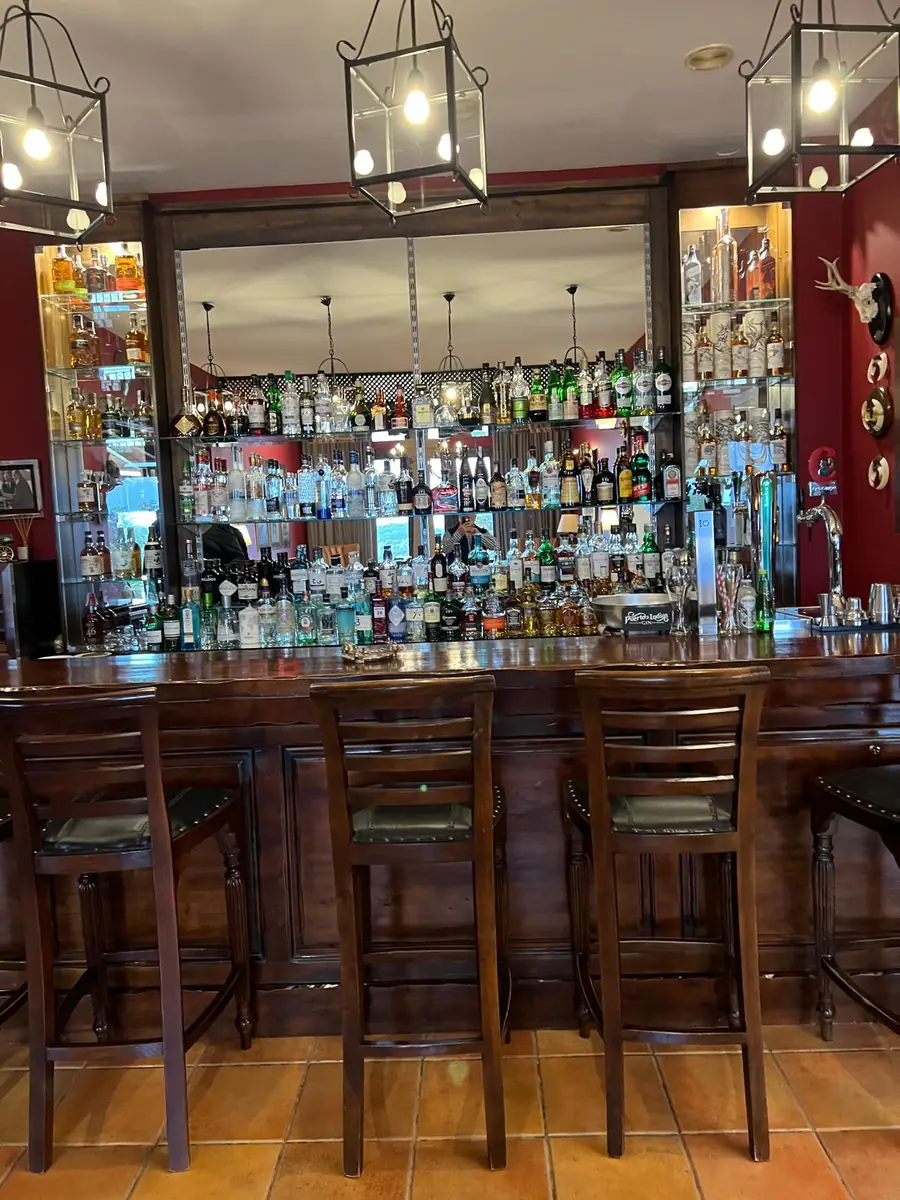 The mahogany lodge bar at La Cuesta stocked with malt whiskies and gins